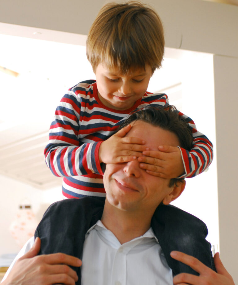 child covering parents' eyes to show blind trust